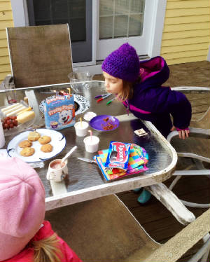 Latke's party Caroline blowing out candles.JPG