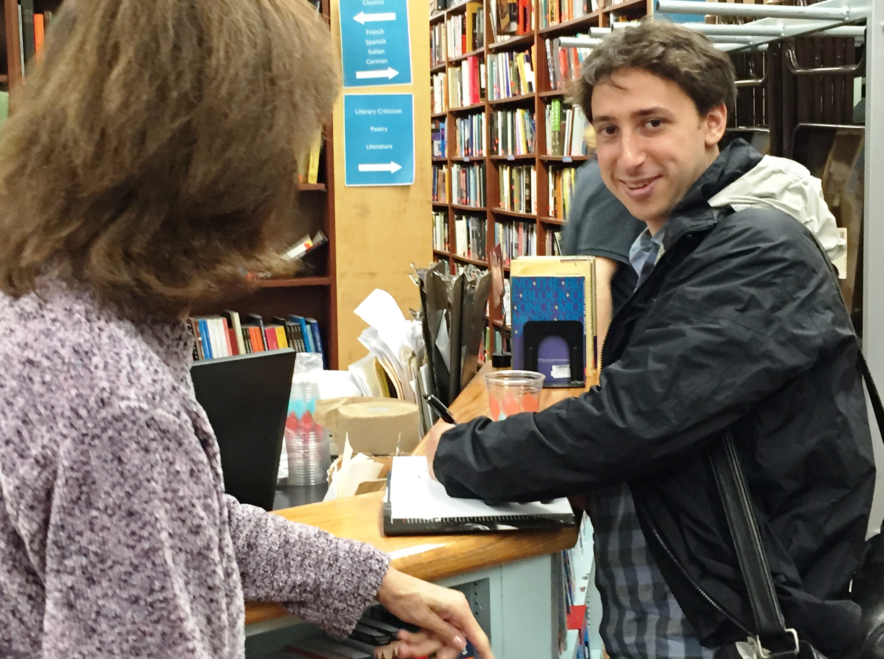 Aidan signing books at Book Culture.JPG